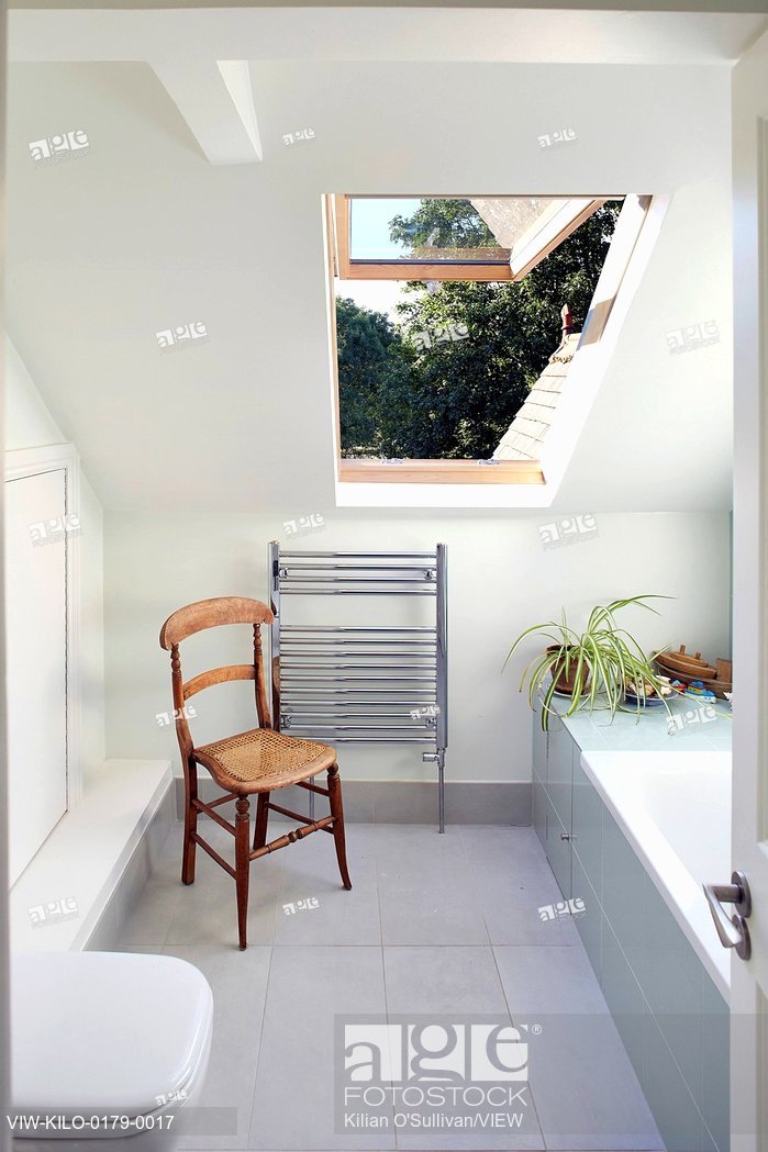 bathrooms pitched roof stock photo: bathroom with pitched roof and velux window. wendell rd,  london, CVOYFMV