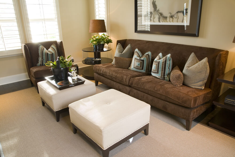 Compact living room with dark mocha chair and armless sofa, contrasting  with white single-