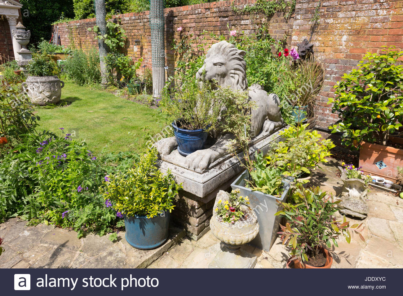 Large garden ornaments including lion statues and pots in an ornate english  garden, Kent England UK