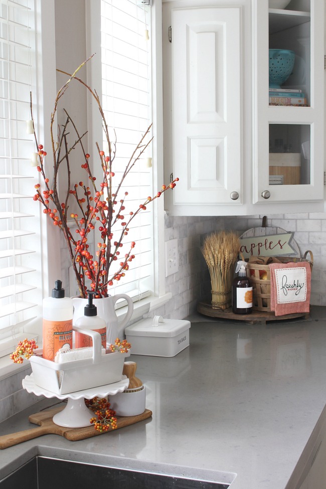 Fall kitchen decor ideas. Faux orange berries and orange dish soap add a  pop of