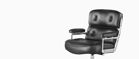 Black leather Eames Executive Chair, offering a close view of the thickly  cushioned seat,