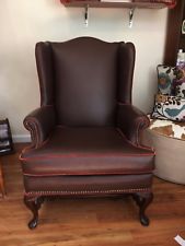brown leather wingback chair with head to head nails