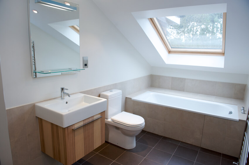 bathrooms pitched roof a minimalist attic bathroom with a natural wood vanity and a tile-enclosed  soaking CRFTRLE