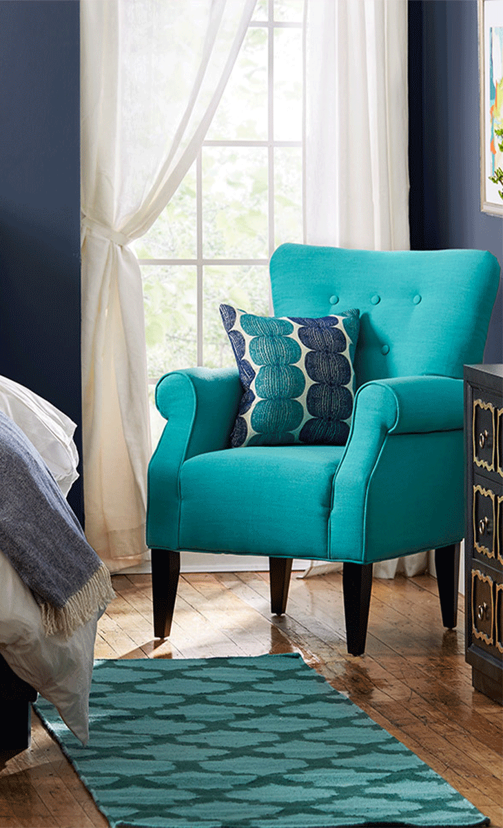Showcasing rolled arms and tapered wood legs, this charming tufted arm chair  brings a pop of style to your living room or library.