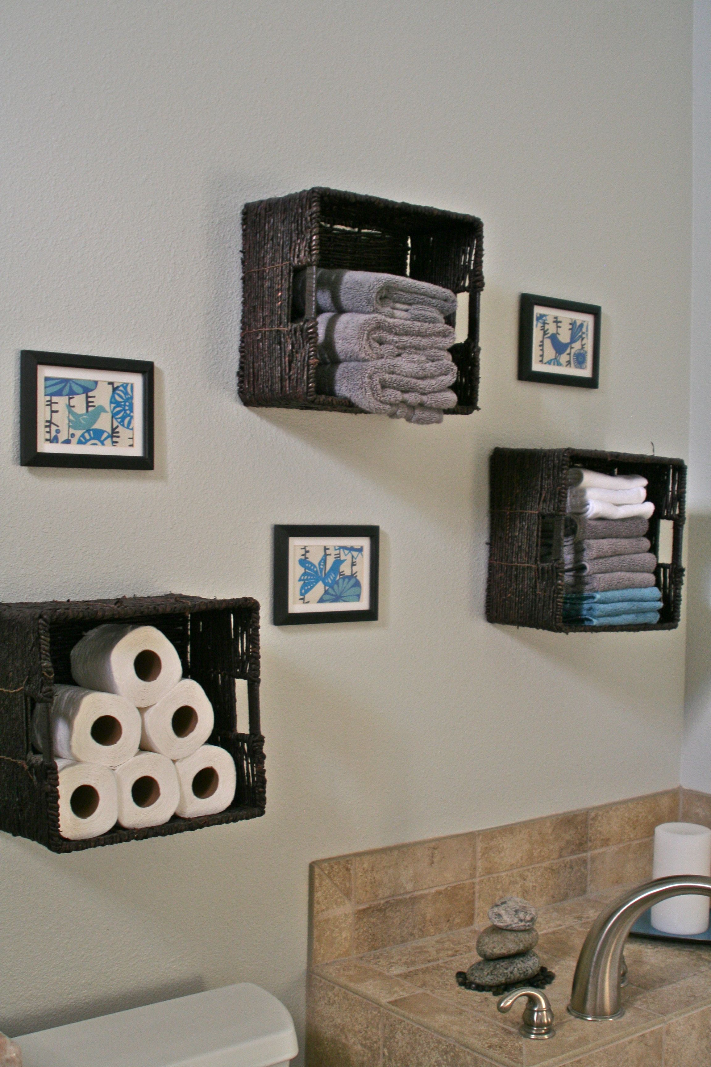 Bathroom storage - baskets for towels, toilet paper etc Love the teal!
