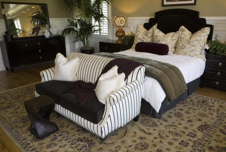 Like the above bedroom, this one places the loveseat at the foot of the bed