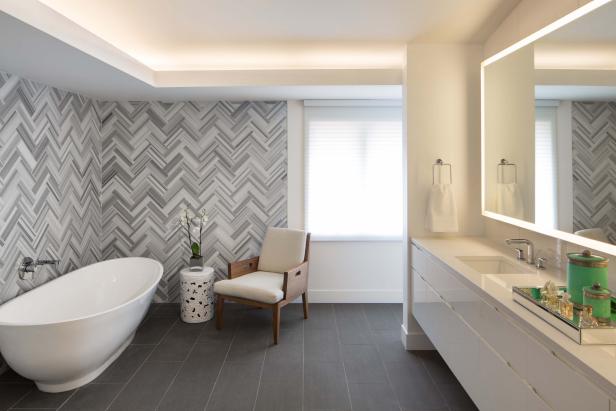 Herringbone Tile Wall Uplifts Modern Master Bathroom