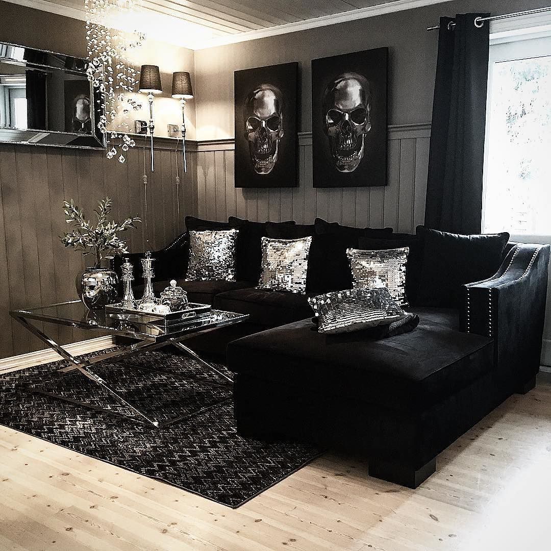 This living room is bad ass. Silver sequin pillows, shiny metallic accents,  dope skull wall art