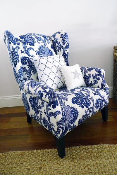 Wing chair upholstered in a blue and white Jacobean print
