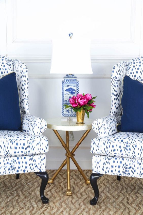 Society Social Wing chairs upholstered in a favorite fabric of mine -  Brunschwig & Fils Les Touches with a blue and white Chinese porcelain lamp  and a pop
