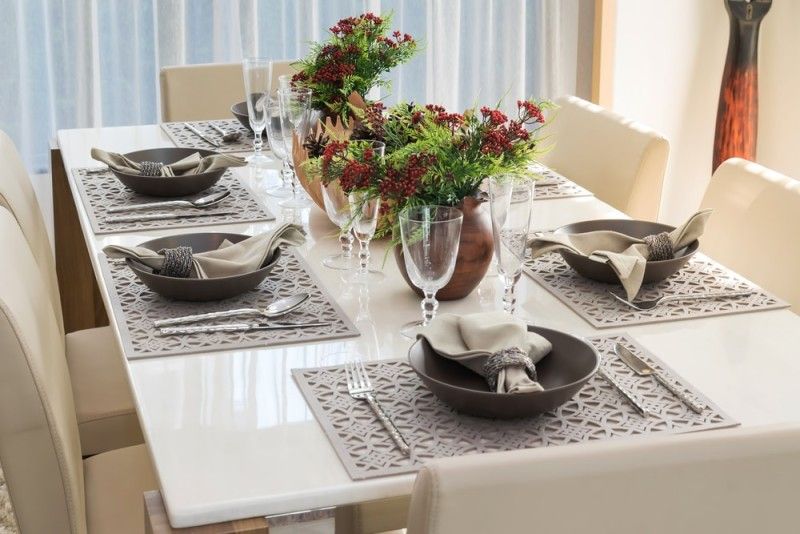Six piece dining table setting with cream colored comfortable chairs and  matching napkins and tablemats