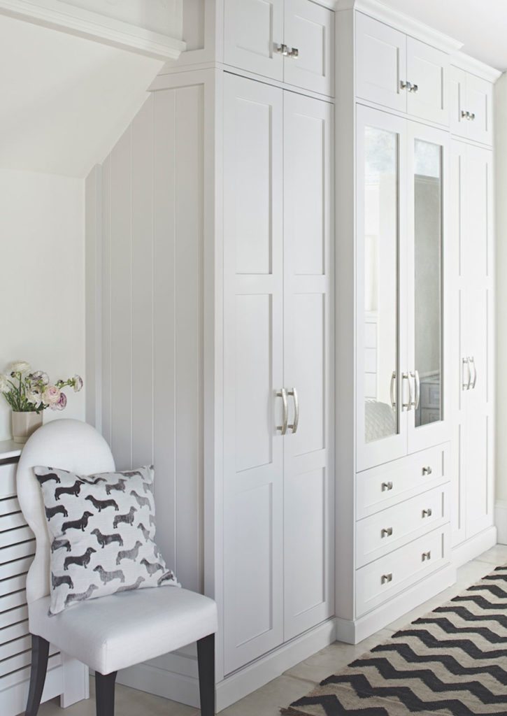 Seen here in white, this Shaker-style in-frame fitted wardrobe, priced from  £5,000 from John Lewis of Hungerford blends beautifully into the bedroom.