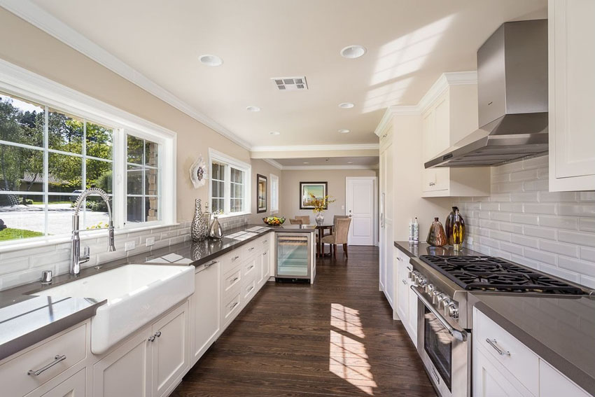 Traditional galley kitchen with white cabinets backsplash