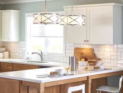Kitchen with a backsplash featuring patterned white subway tile.