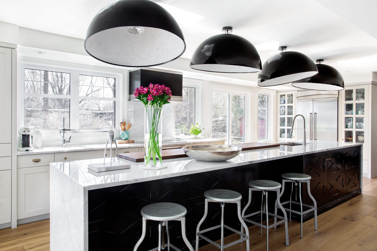 Stunning white and black modern kitchen with medium dark wood flooring.  Actually, this kitchen