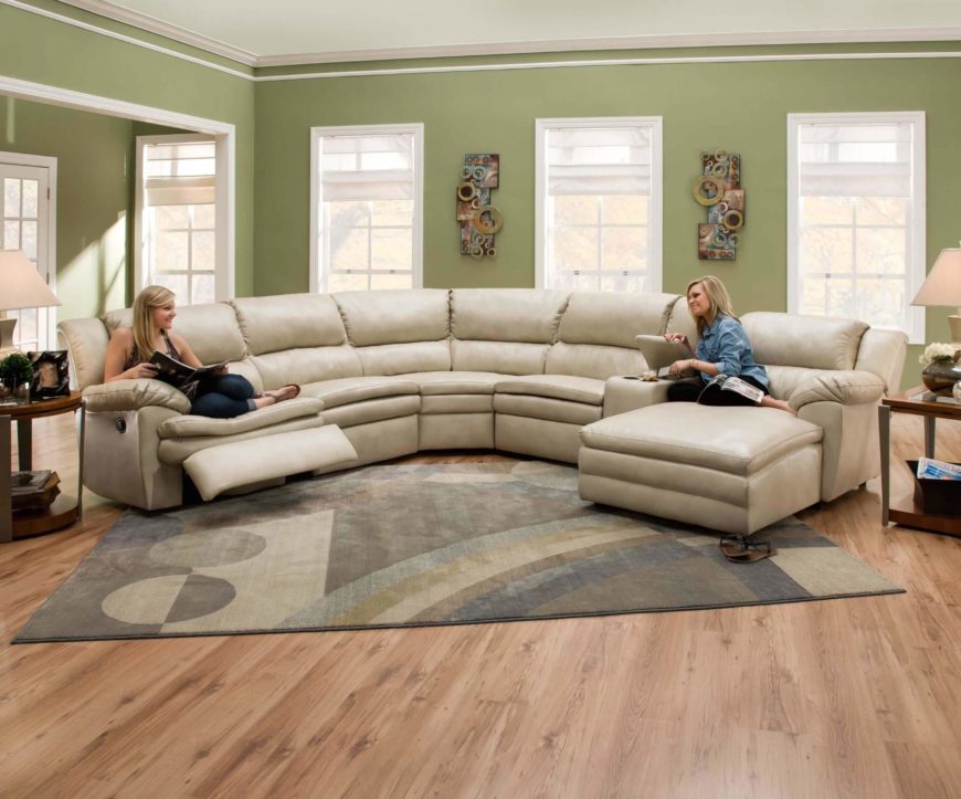 Soft wheat toned leather wraps this thick cushioned sectional, a lengthy  piece incorporating both a .