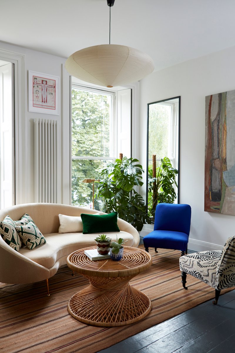 British interior designer Beata Heuman brought organic modernism to a flat  in Holland Park, London via the grouping of a cream-colored round sofa with  a
