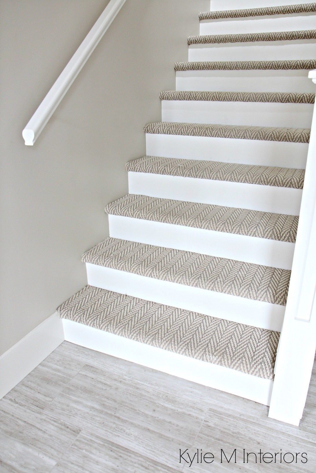 Stairs with carpet herringbone treads and painted white risers, looks like  a runner. Benjamin Moore Edgecomb Gray on stairwell wall.