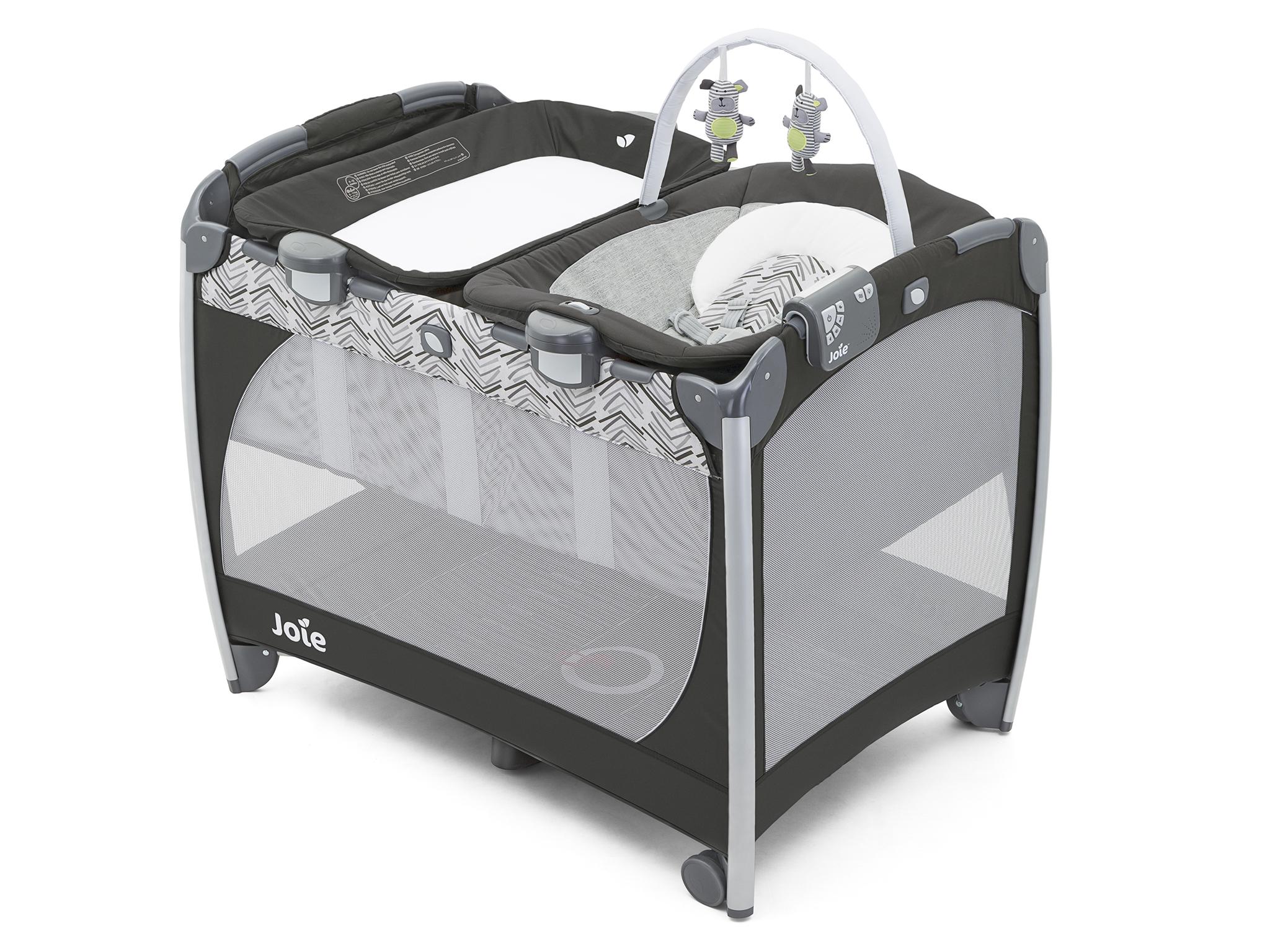 This is a lot more than just a travel cot: it includes a portable changing  unit that can be placed on top of the cot, a bouncy seat with a music (five