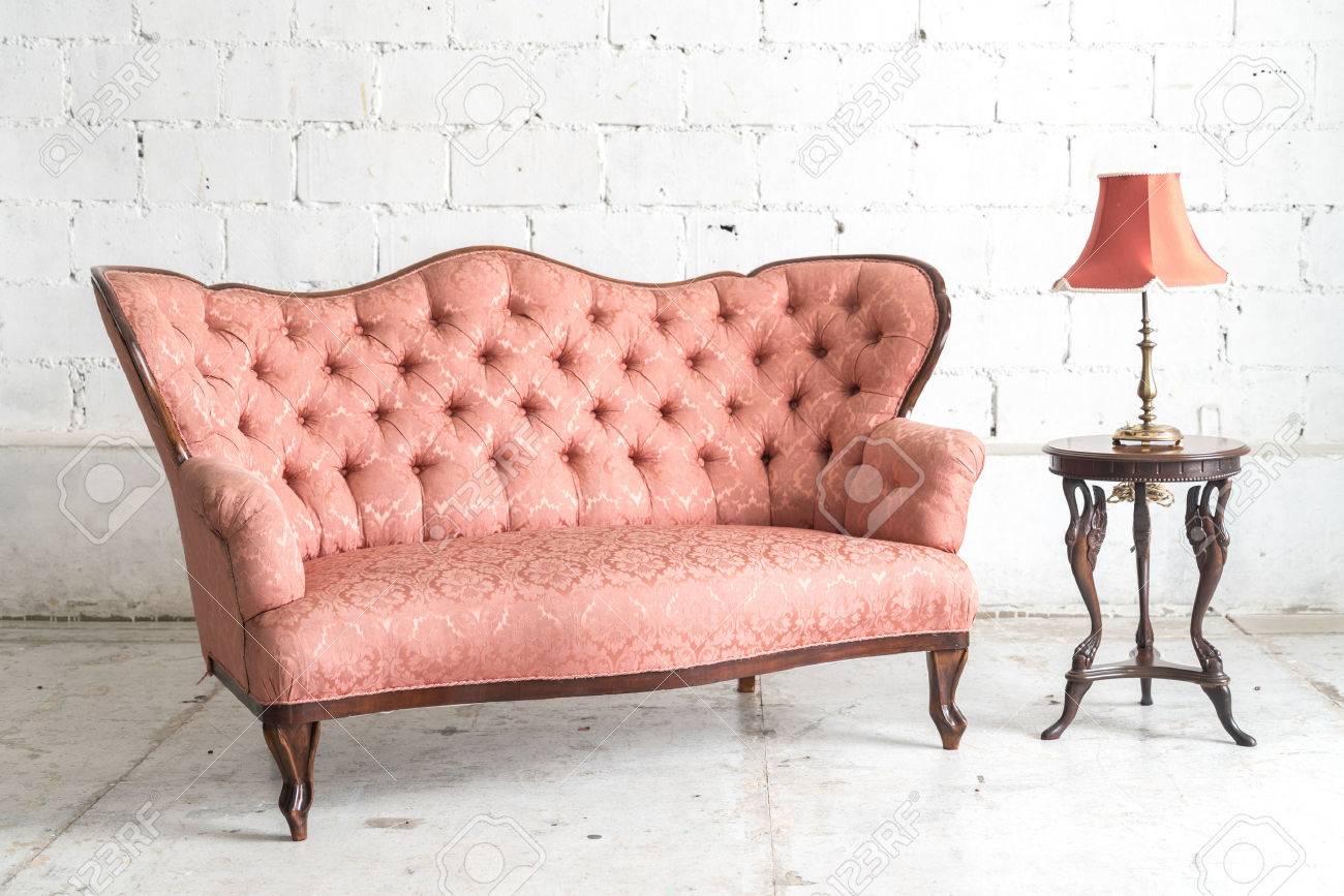 Pink vintage sofa and lamp on white wall. Stock Photo - 60981762