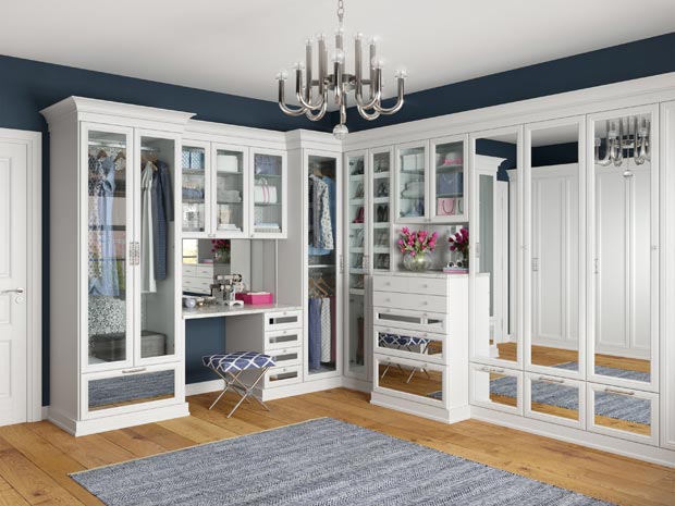 Glamorous white walk in closet with mirror insert door and drawer styles by  California Closets