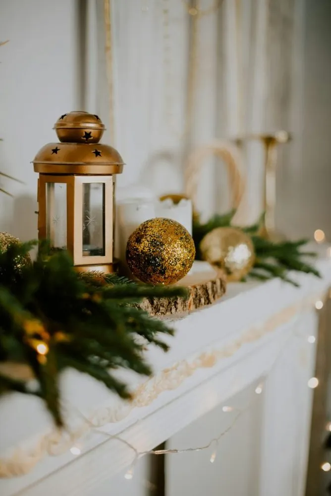 Wood slice riser with brass lantern and ornaments